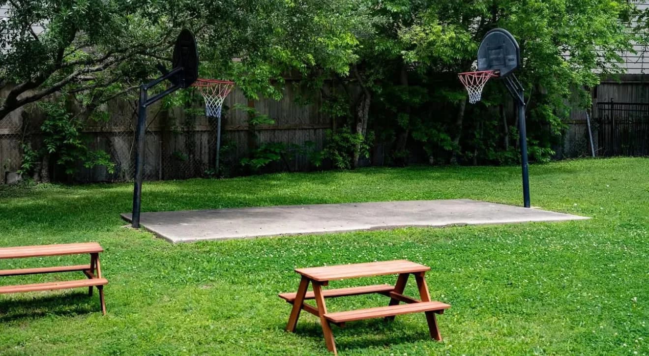Children playing outdoors at a Garden Montessori campus