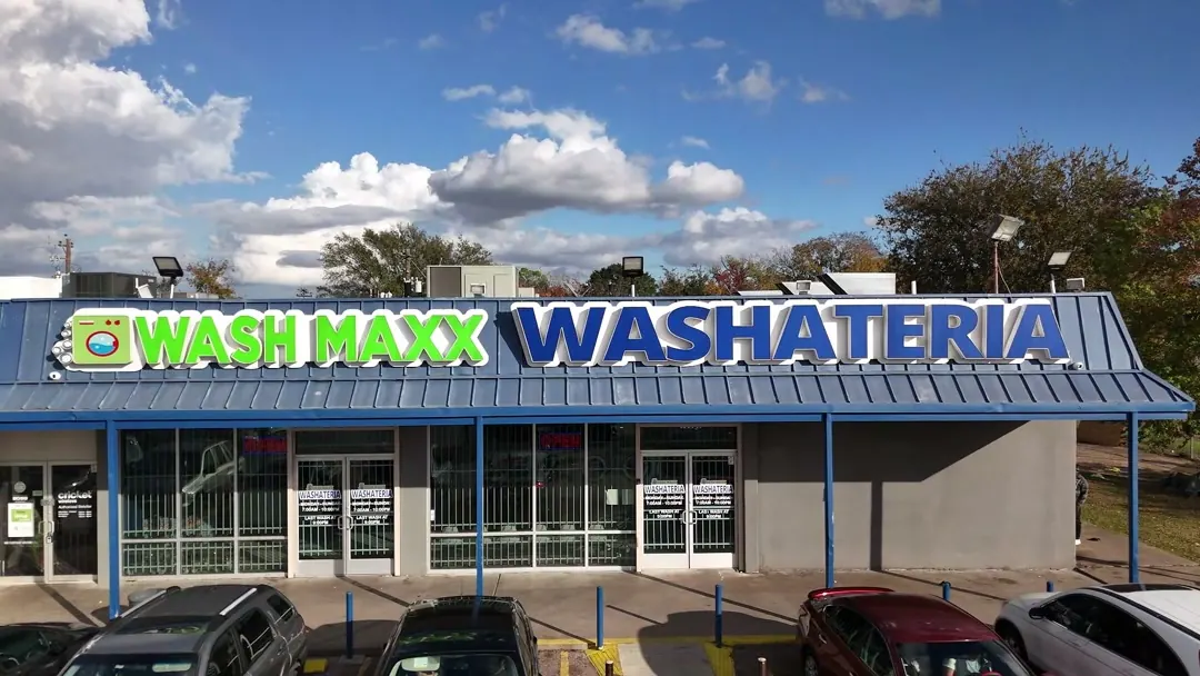 The WashMaxx storefront under a blue sky